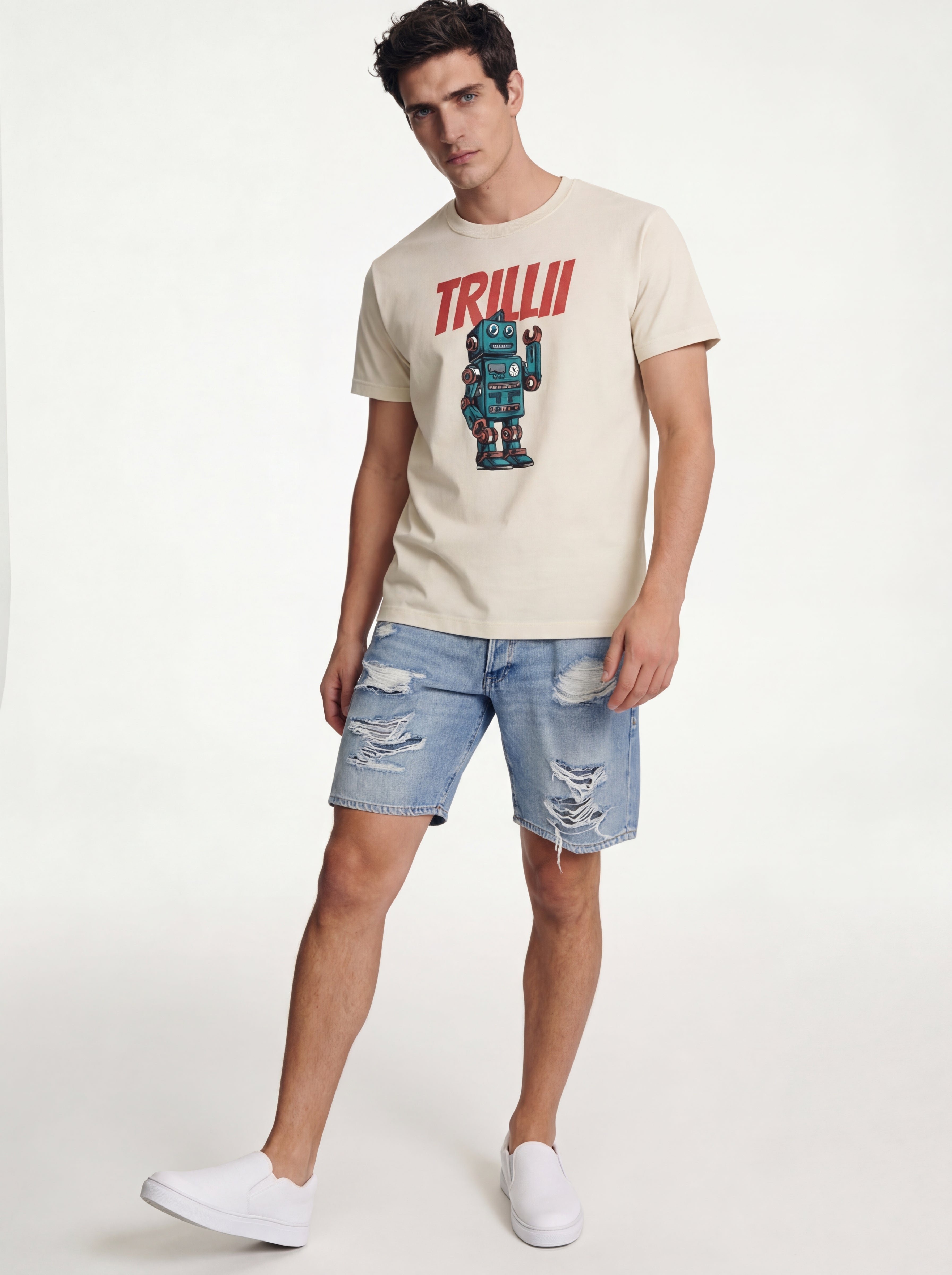 Man wearing a beige t-shirt with a robot graphic and 'TRILLI' text, paired with ripped denim shorts on a white background.